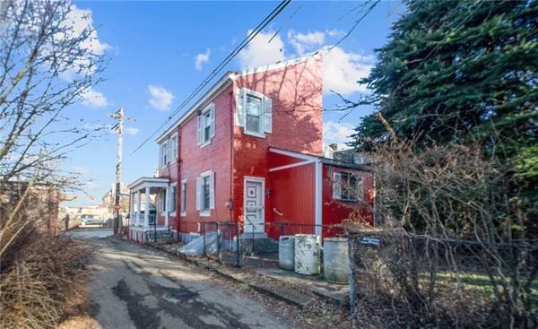 a view of a brick house with a yard