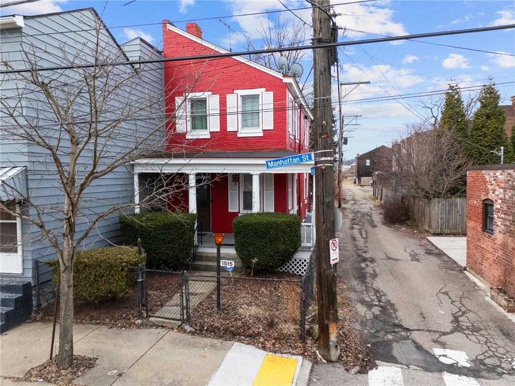 1515 Manhattan Street Pittsburgh, PA 15233 - Photo 38 of 46 a view of a brick house with a yard