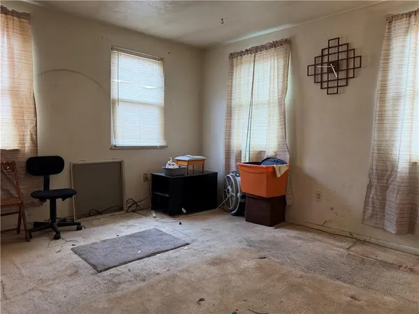 a bedroom with furniture and a window