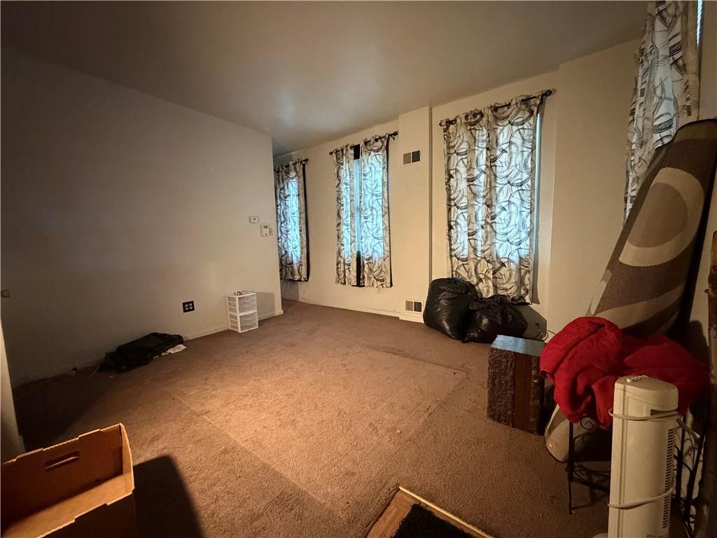 1515 Manhattan Street Pittsburgh, PA 15233 - Photo 8 of 46 a bed room with a bed and a chair