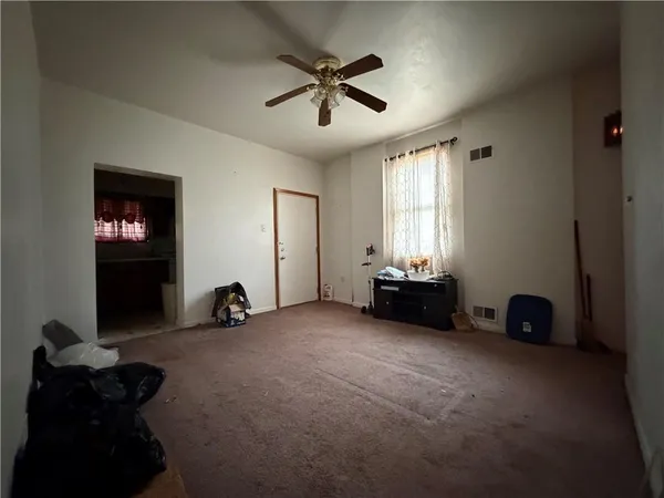 a view of room with gym equipment and a large window