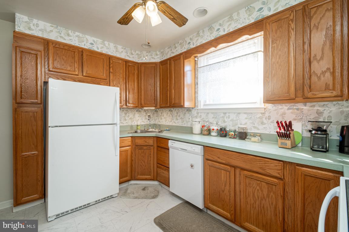8504 Bassett Road Baltimore, MD 21237 - Photo 12 of 35 a kitchen with sink refrigerator and cabinets
