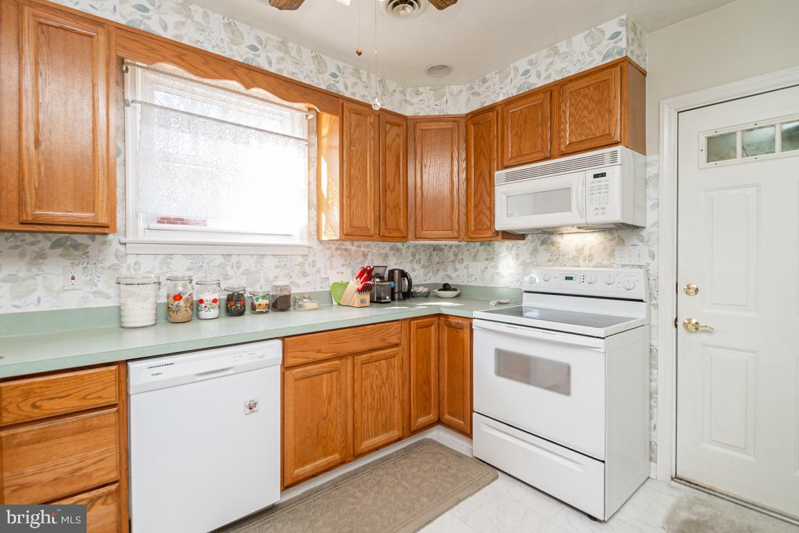 8504 Bassett Road Baltimore, MD 21237 - Photo 13 of 35 a kitchen with stainless steel appliances granite countertop a sink and cabinets