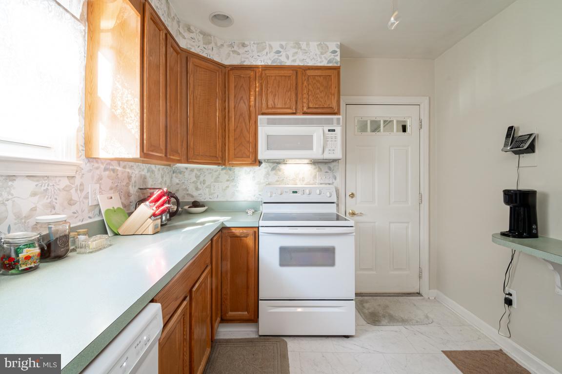 8504 Bassett Road Baltimore, MD 21237 - Photo 14 of 35 a kitchen with stainless steel appliances white cabinets and a refrigerator