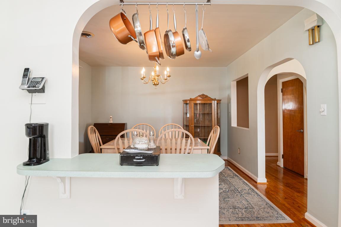 8504 Bassett Road Baltimore, MD 21237 - Photo 15 of 35 a view of dining room and kitchen with furniture
