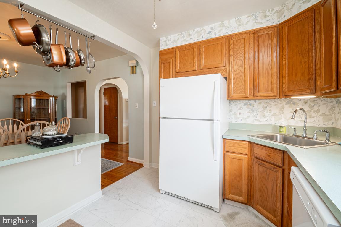8504 Bassett Road Baltimore, MD 21237 - Photo 16 of 35 a kitchen with stainless steel appliances granite countertop a refrigerator a sink a stove top oven a counter space and cabinets