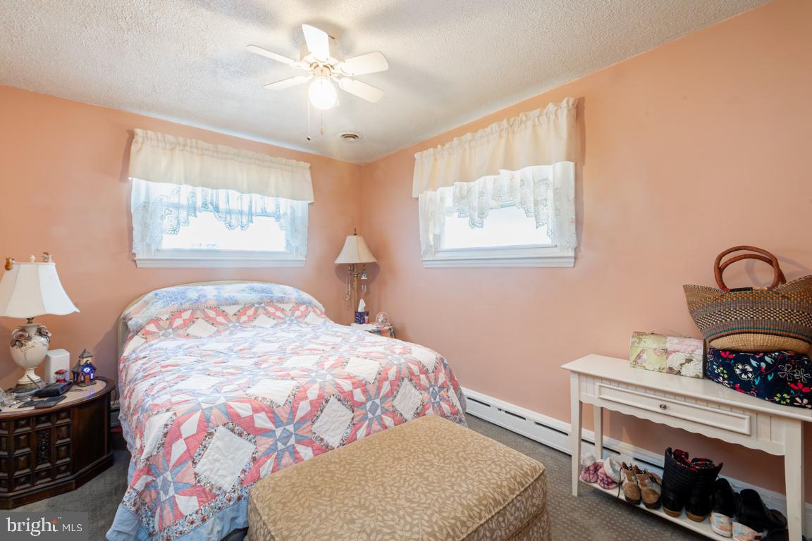 8504 Bassett Road Baltimore, MD 21237 - Photo 17 of 35 a bedroom with a bed and a chandelier