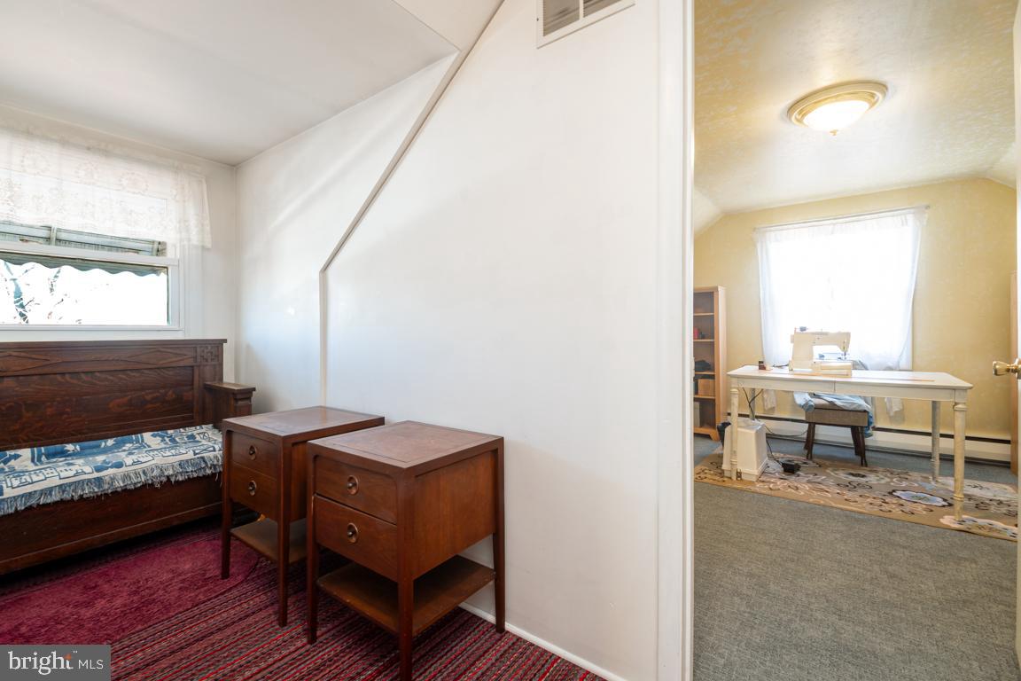 8504 Bassett Road Baltimore, MD 21237 - Photo 22 of 35 a bedroom with a bed and large windows