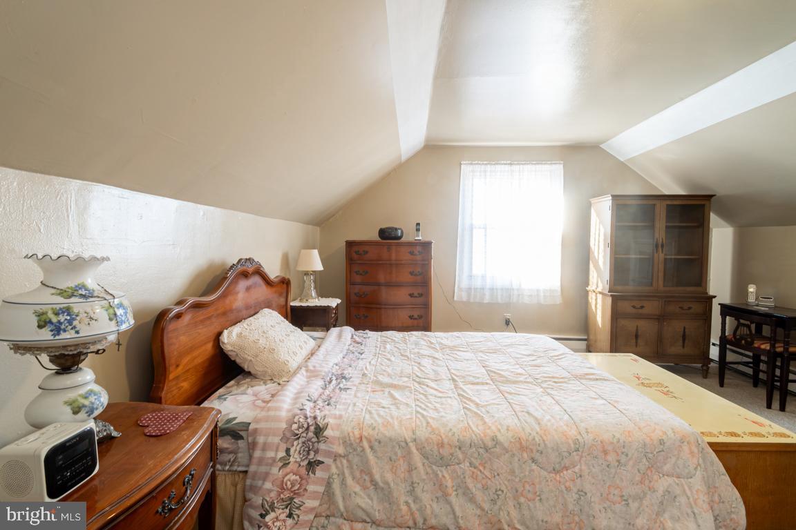 8504 Bassett Road Baltimore, MD 21237 - Photo 26 of 35 a large bed sitting in a bedroom and a table