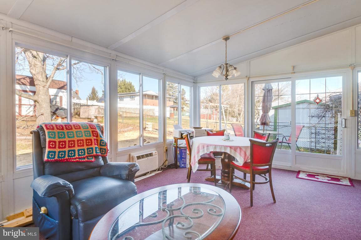 8504 Bassett Road Baltimore, MD 21237 - Photo 31 of 35 a living room with furniture and a floor to ceiling window