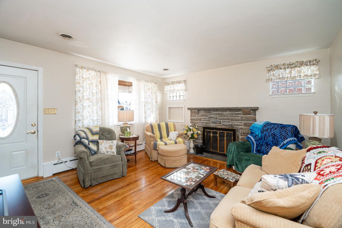 8504 Bassett Road Baltimore, MD 21237 - Photo 8 of 35 a living room with furniture fireplace and a large window