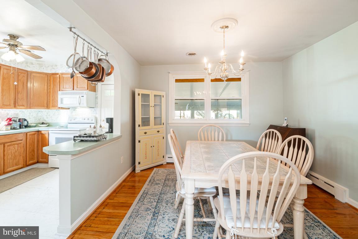 8504 Bassett Road Baltimore, MD 21237 - Photo 9 of 35 a view of dining room and kitchen with wooden floor