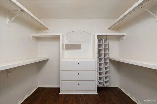 a view of walk in closet with empty racks
