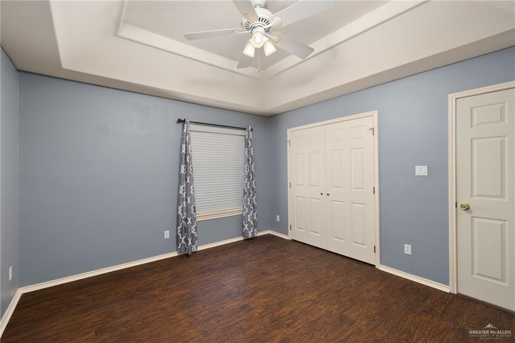2111 East 25th Street Mission, TX 78574 - Photo 12 of 19 an empty room with wooden floor and ceiling fan