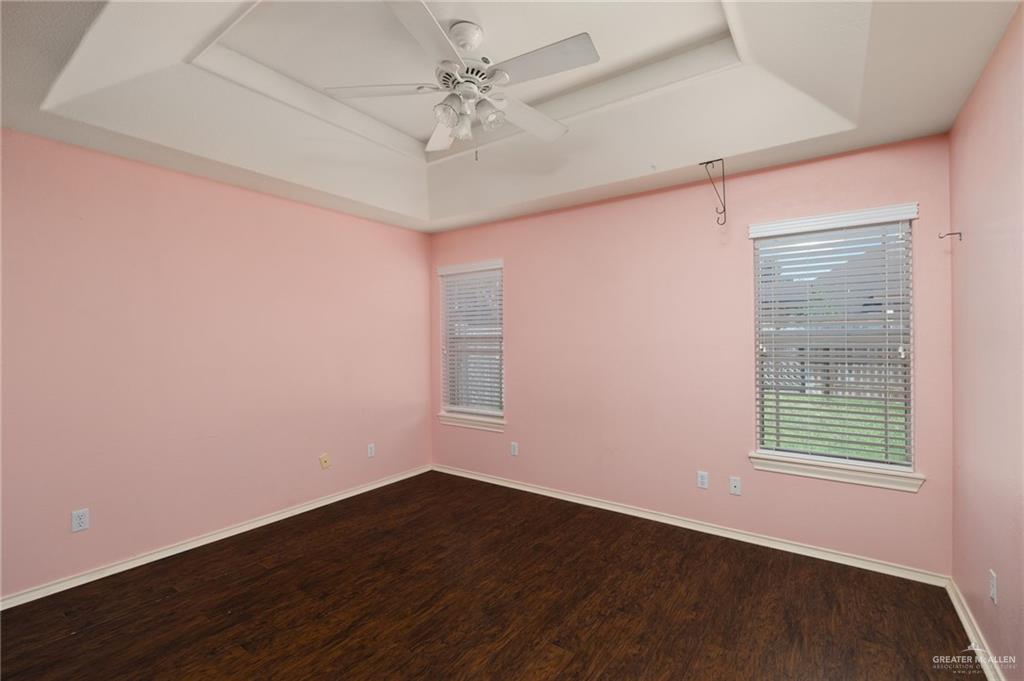 2111 East 25th Street Mission, TX 78574 - Photo 13 of 19 an empty room with wooden floor and windows