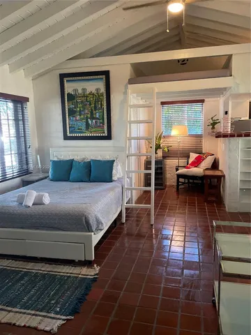 a view of a porch with a table and chairs