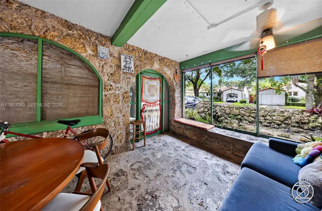 a living room with a bed furniture and a window