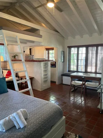 a room with furniture pool table flat screen tv and windows