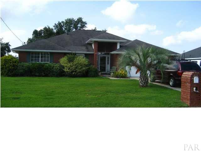 5861 Admirals Road Milton, FL 32583 - Photo 1 of 24 Front of home - note the nice landscaping and palm!