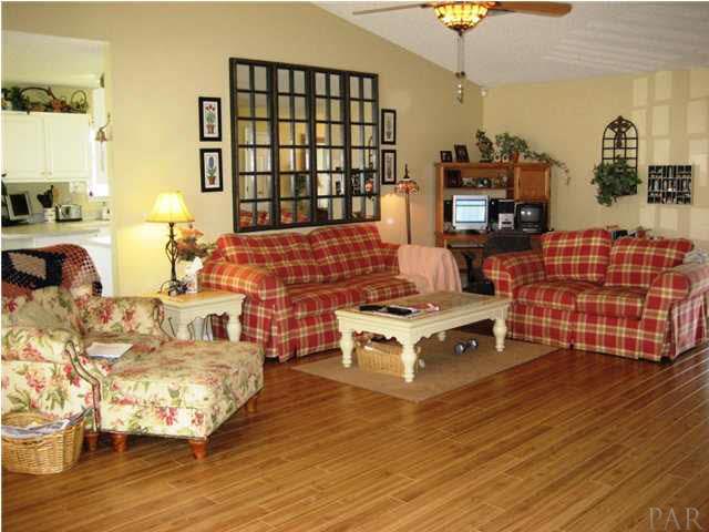 5861 Admirals Road Milton, FL 32583 - Photo 2 of 24 Large living room with beautiful laminate wood flooring!