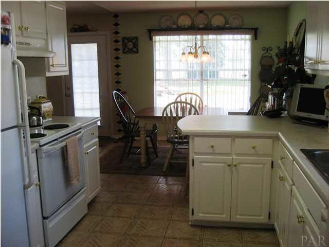 5861 Admirals Road Milton, FL 32583 - Photo 7 of 24 View of kitchen and dining area from laundry.