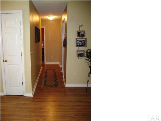 5861 Admirals Road Milton, FL 32583 - Photo 9 of 24 Hallway leads to bedrooms.