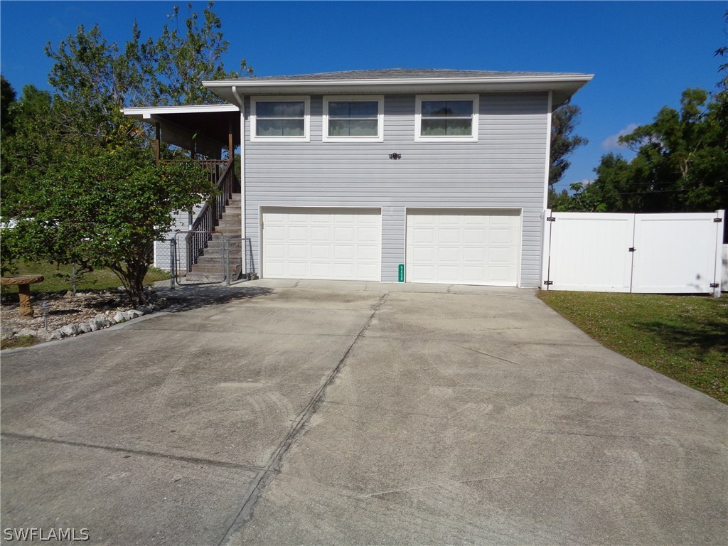 5458 Judith Road Bokeelia, FL 33922 - Photo 1 of 25 a front view of a house with garage