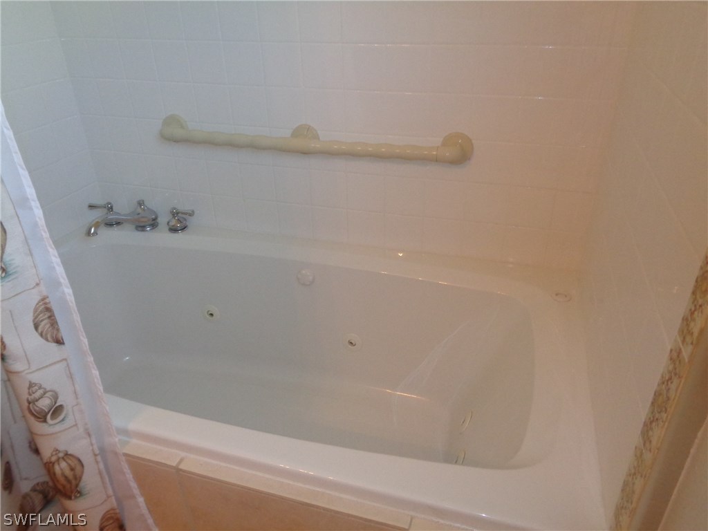 5458 Judith Road Bokeelia, FL 33922 - Photo 11 of 25 a bathroom with a bathtub