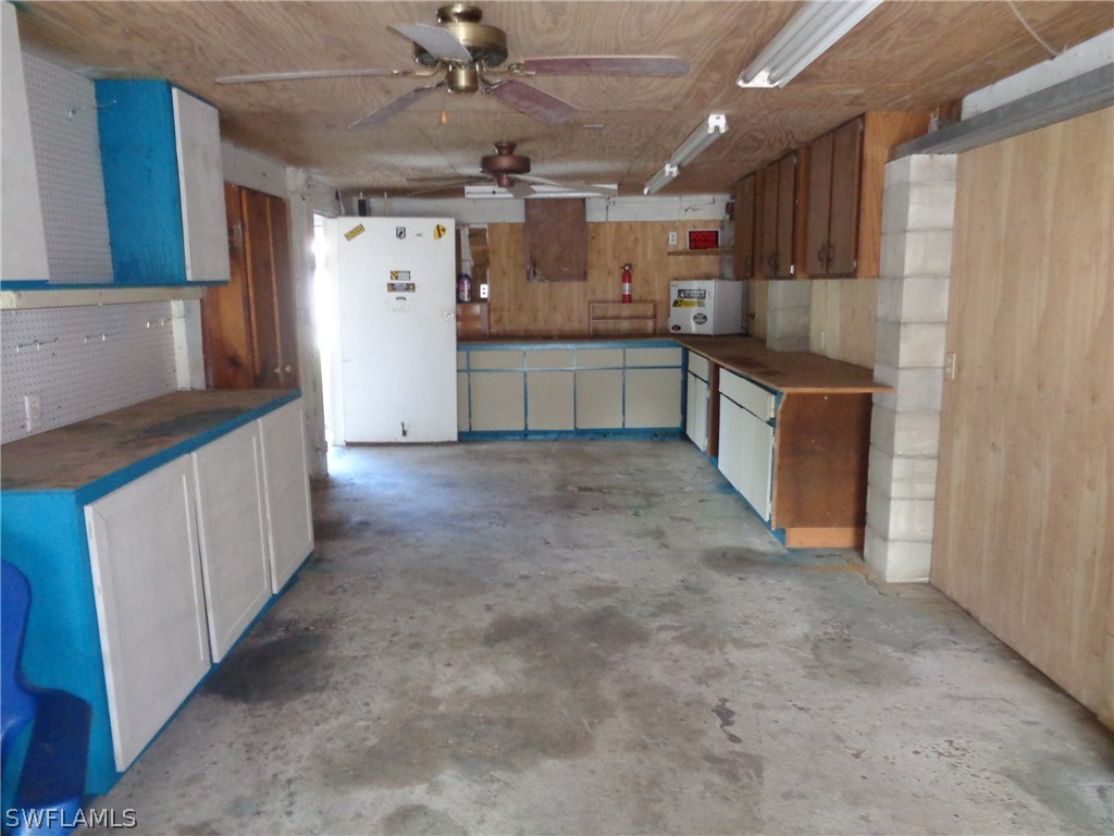 5458 Judith Road Bokeelia, FL 33922 - Photo 21 of 25 a open kitchen with cabinets and stainless steel appliances