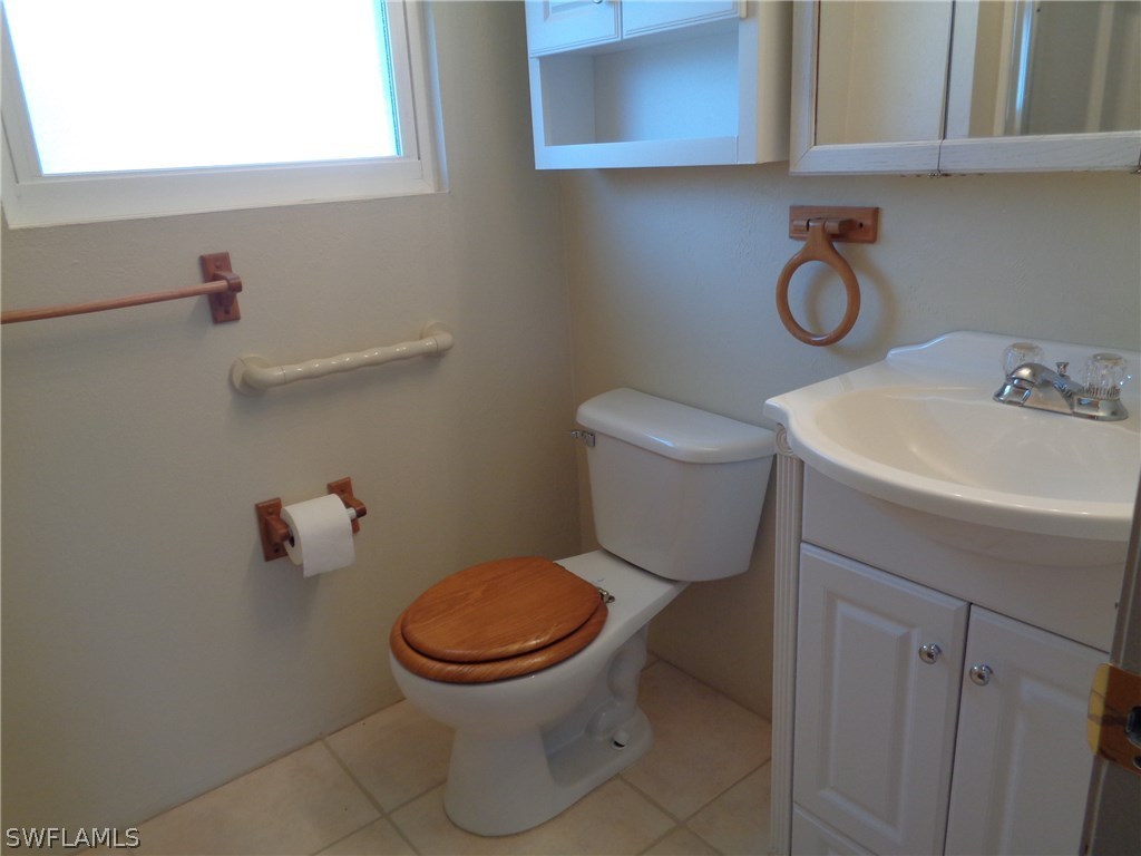 5458 Judith Road Bokeelia, FL 33922 - Photo 7 of 25 a white toilet sitting next to a bathroom sink