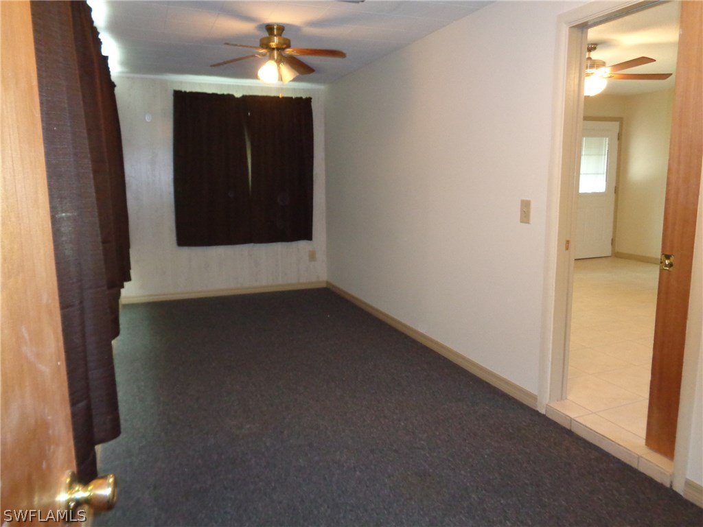 5458 Judith Road Bokeelia, FL 33922 - Photo 9 of 25 an empty room with windows and entrance
