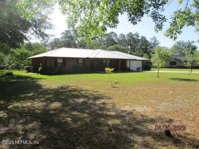 11375 Pine Loop Glen St. Mary, FL 32040 - Photo 2 of 33 a view of a house with a yard and large trees