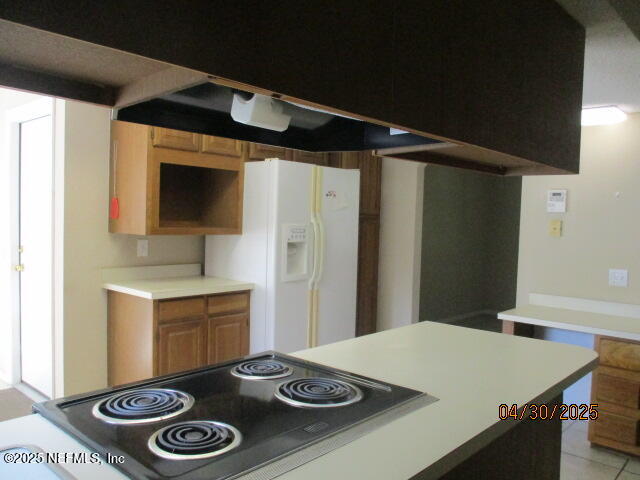 11375 Pine Loop Glen St. Mary, FL 32040 - Photo 7 of 33 a kitchen with a stove and a refrigerator