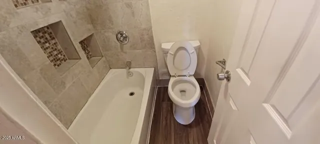 a view of a room with wooden floor and windows