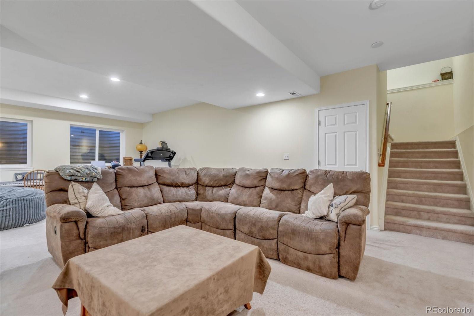 4786 Rabbit Mountain Road Broomfield, CO 80020 - Photo 29 of 41 a living room with furniture and a wooden floor