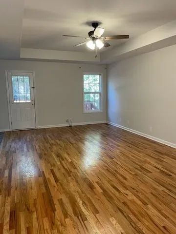 wooden floor in an empty room with a window