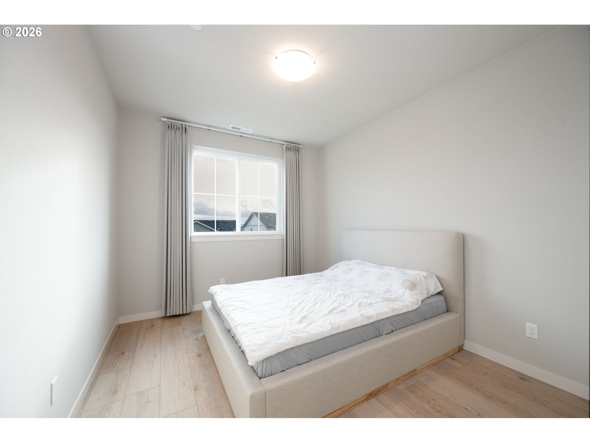 16800 Southwest Dowitcher Lane Beaverton, OR 97007 - Photo 15 of 48 a bedroom with a bed and window