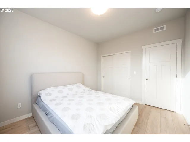 a bedroom with a bed and a night stand