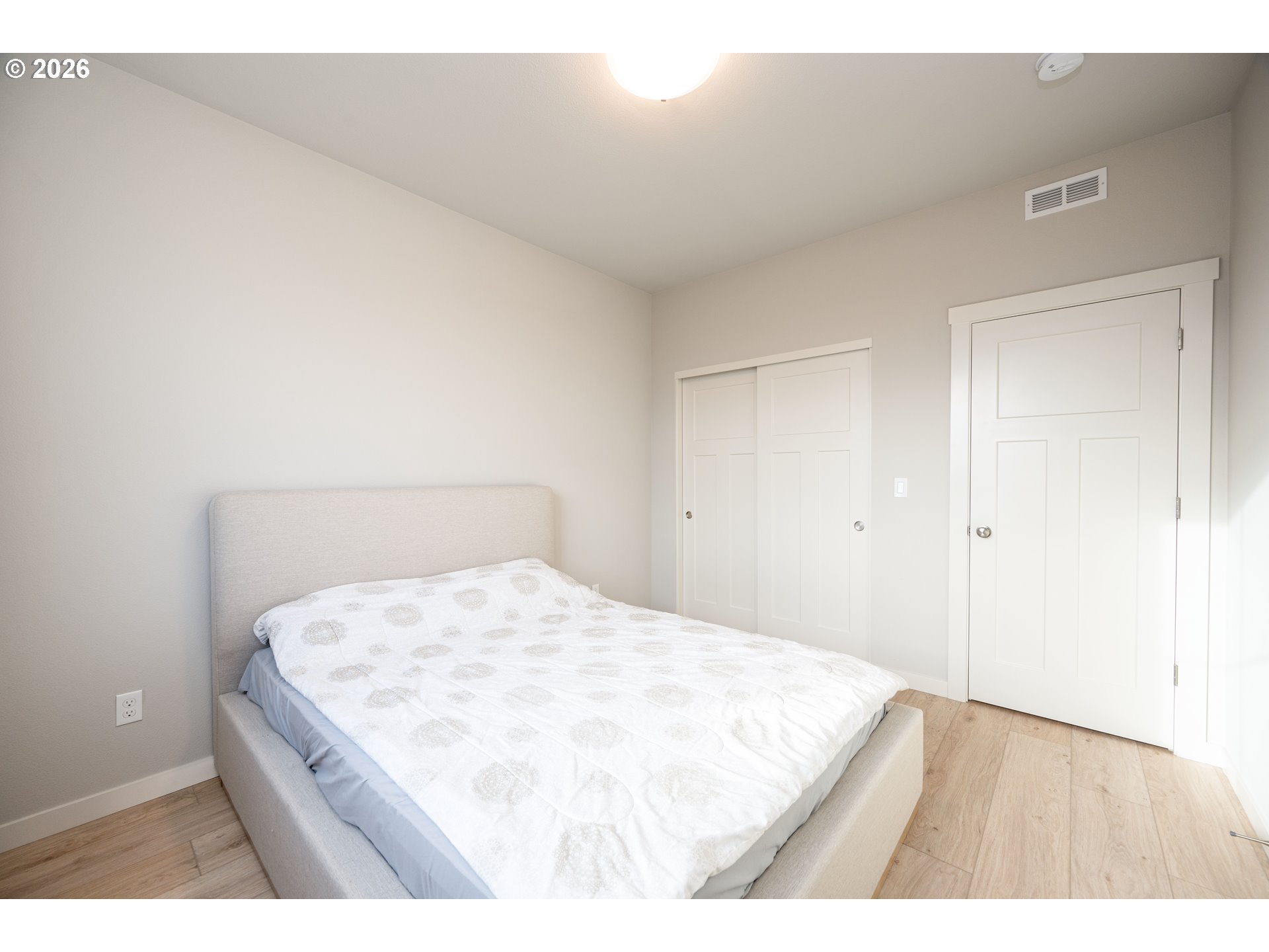 16800 Southwest Dowitcher Lane Beaverton, OR 97007 - Photo 16 of 48 a bedroom with a bed and a night stand