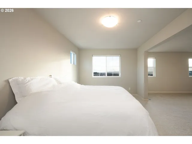 a large white bed in a white room