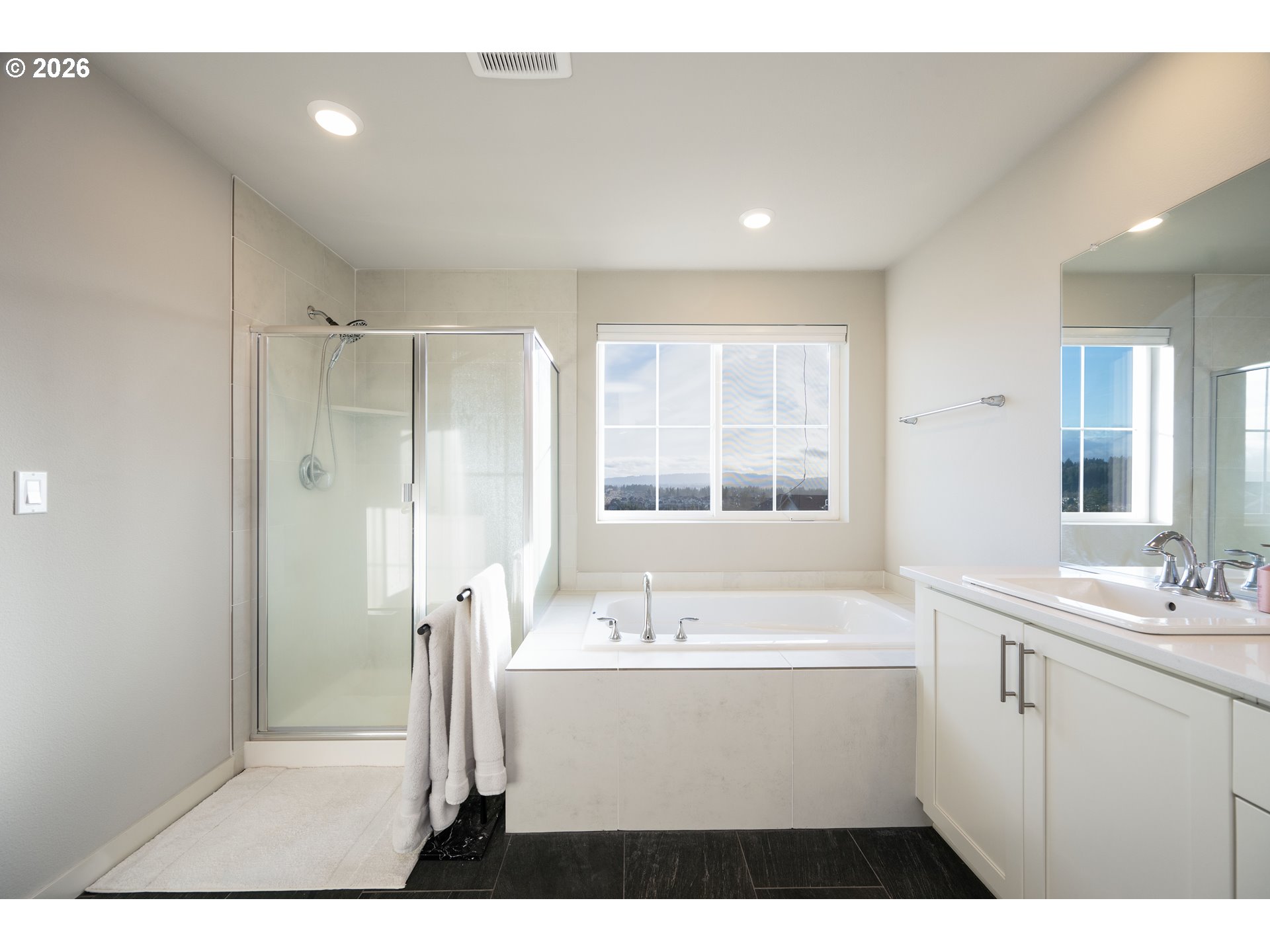 16800 Southwest Dowitcher Lane Beaverton, OR 97007 - Photo 26 of 48 a bathroom with a sink a mirror a vanity and a bathtub