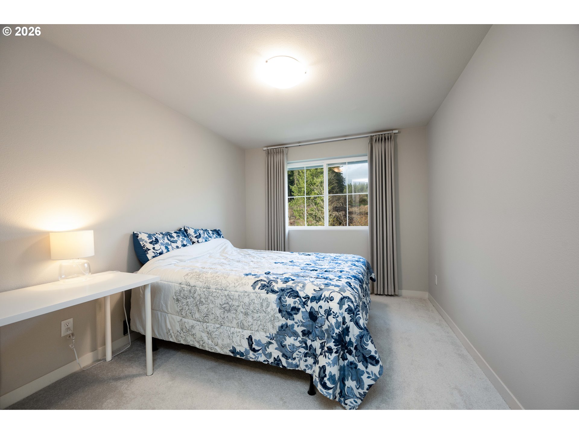 16800 Southwest Dowitcher Lane Beaverton, OR 97007 - Photo 30 of 48 a bedroom with a bed and a window