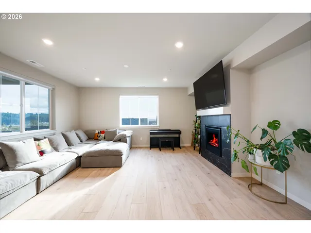 a living room with furniture a fireplace and a flat screen tv