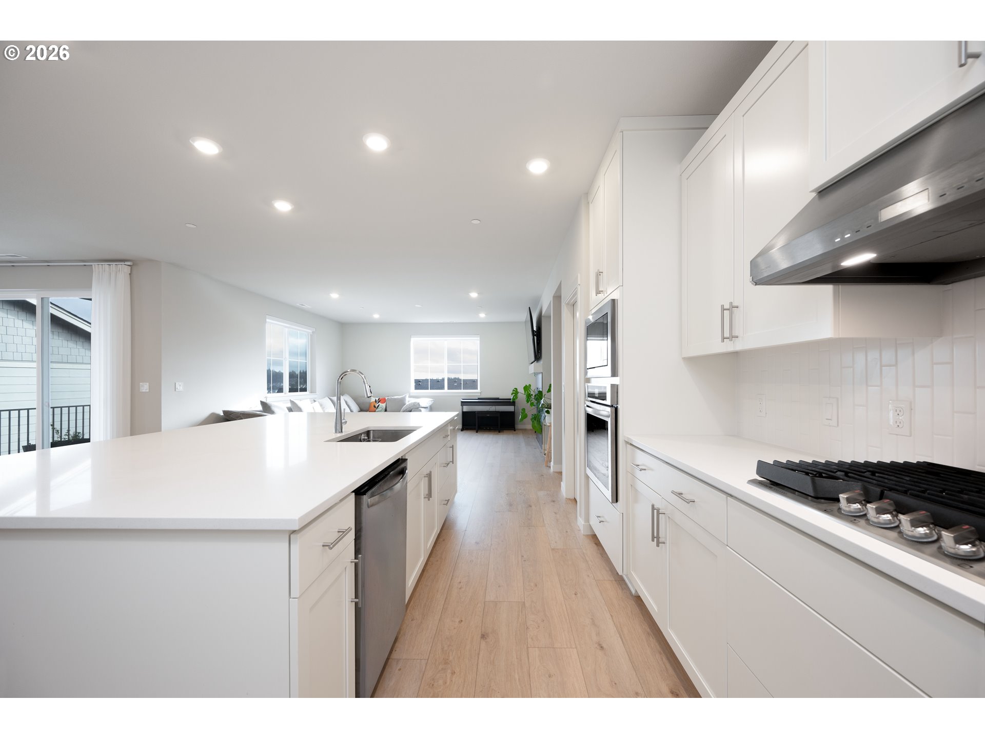 16800 Southwest Dowitcher Lane Beaverton, OR 97007 - Photo 10 of 48 a kitchen with stainless steel appliances a sink a stove top oven a counter space and cabinets