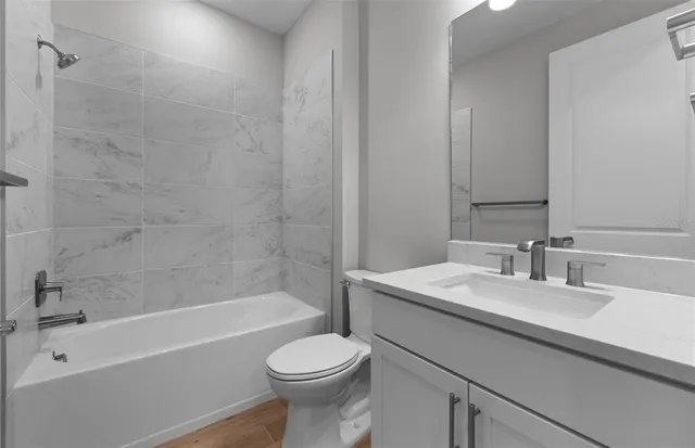 a bathroom with a sink a toilet and bathtub