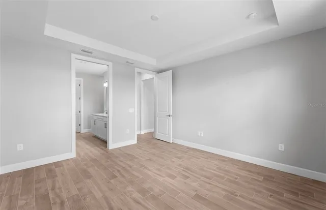 a view of an empty room and wooden floor