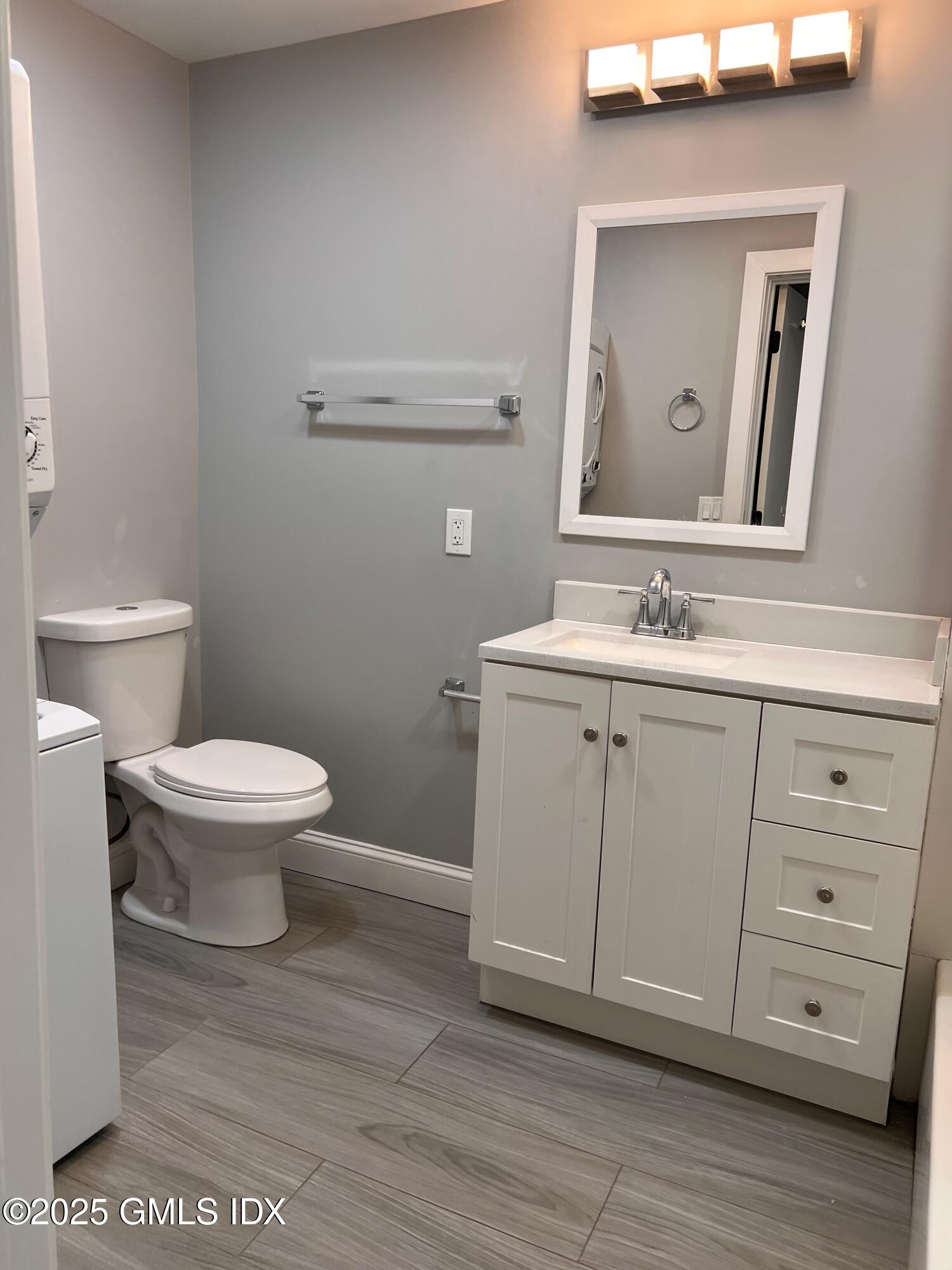 15 Beech Street, Unit 2N Greenwich, CT 06830 - Photo 12 of 15 a bathroom with a toilet a sink and mirror