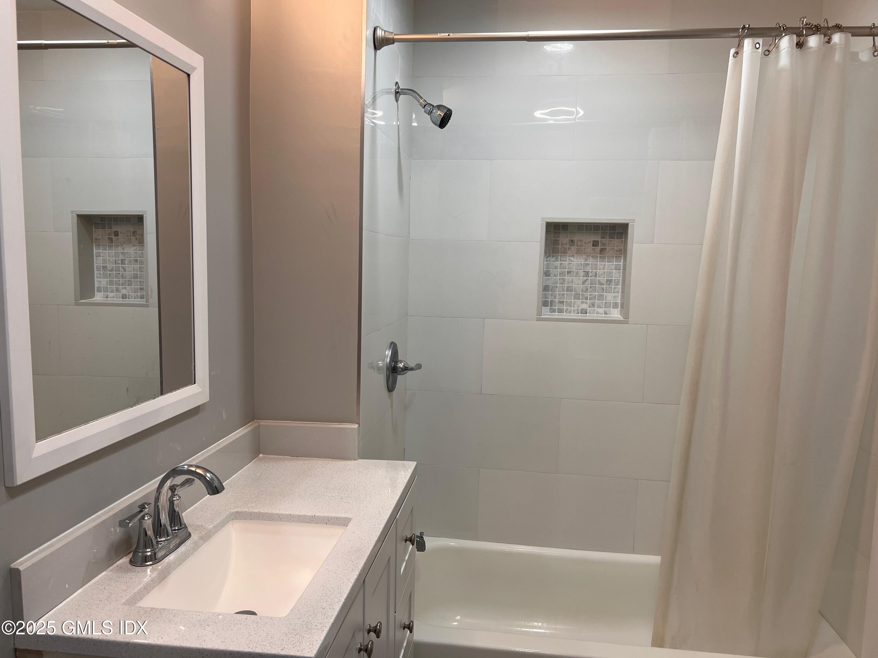 15 Beech Street, Unit 2N Greenwich, CT 06830 - Photo 13 of 15 a bathroom with a sink and a mirror