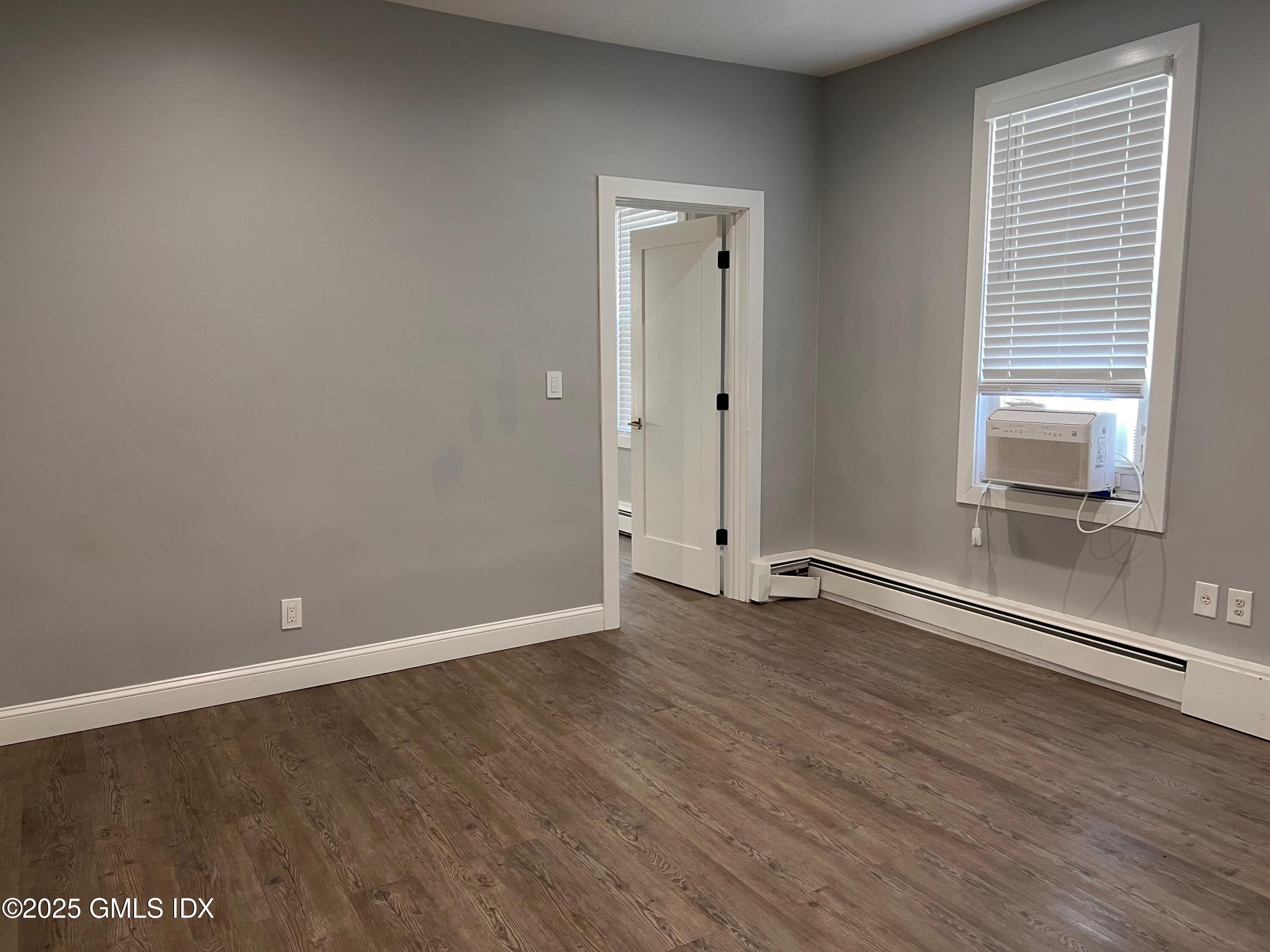 15 Beech Street, Unit 2N Greenwich, CT 06830 - Photo 3 of 15 a view of an empty room with wooden floor and a window