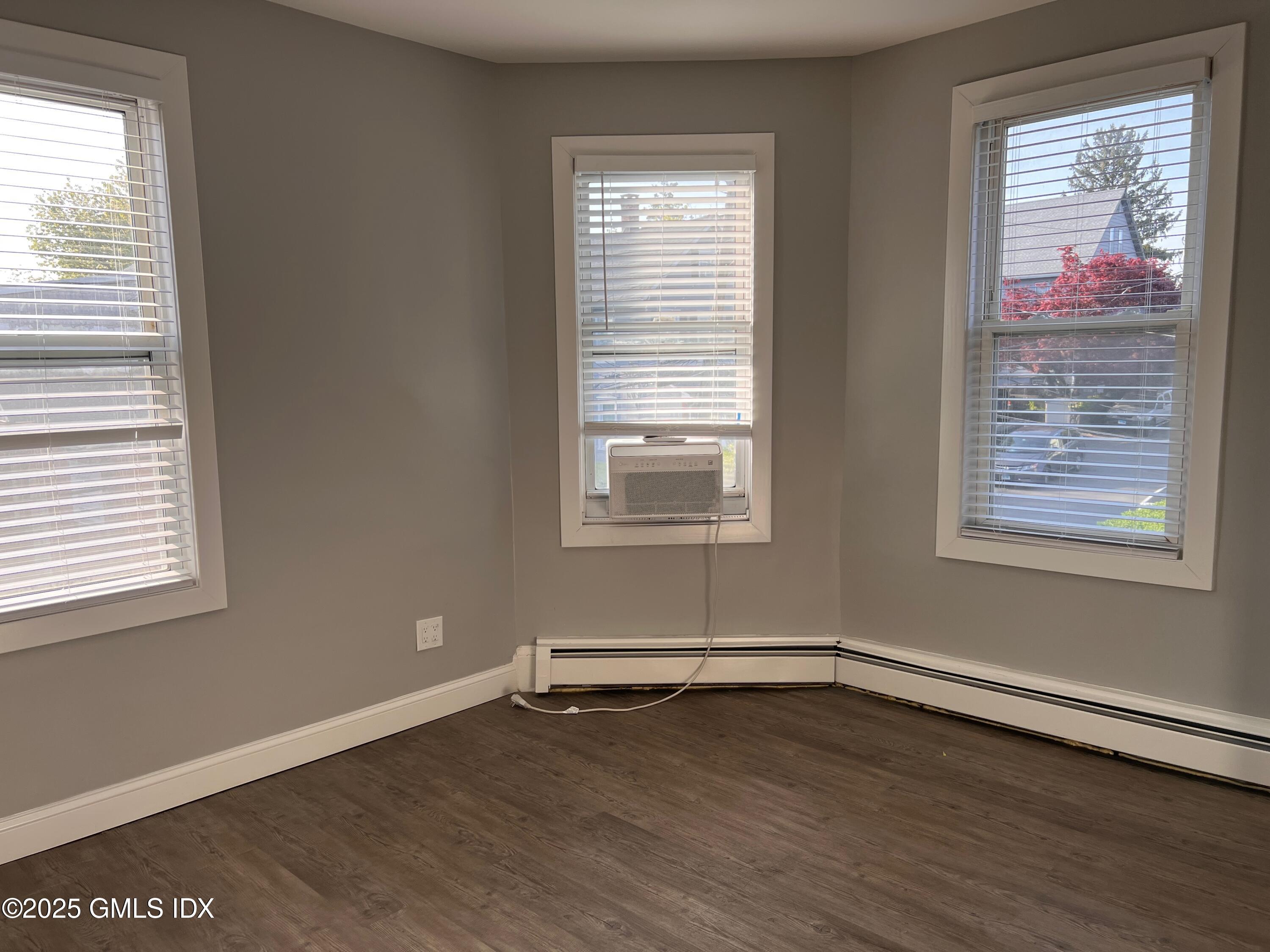 15 Beech Street, Unit 2N Greenwich, CT 06830 - Photo 4 of 15 a view of an empty room with wooden floor and a window